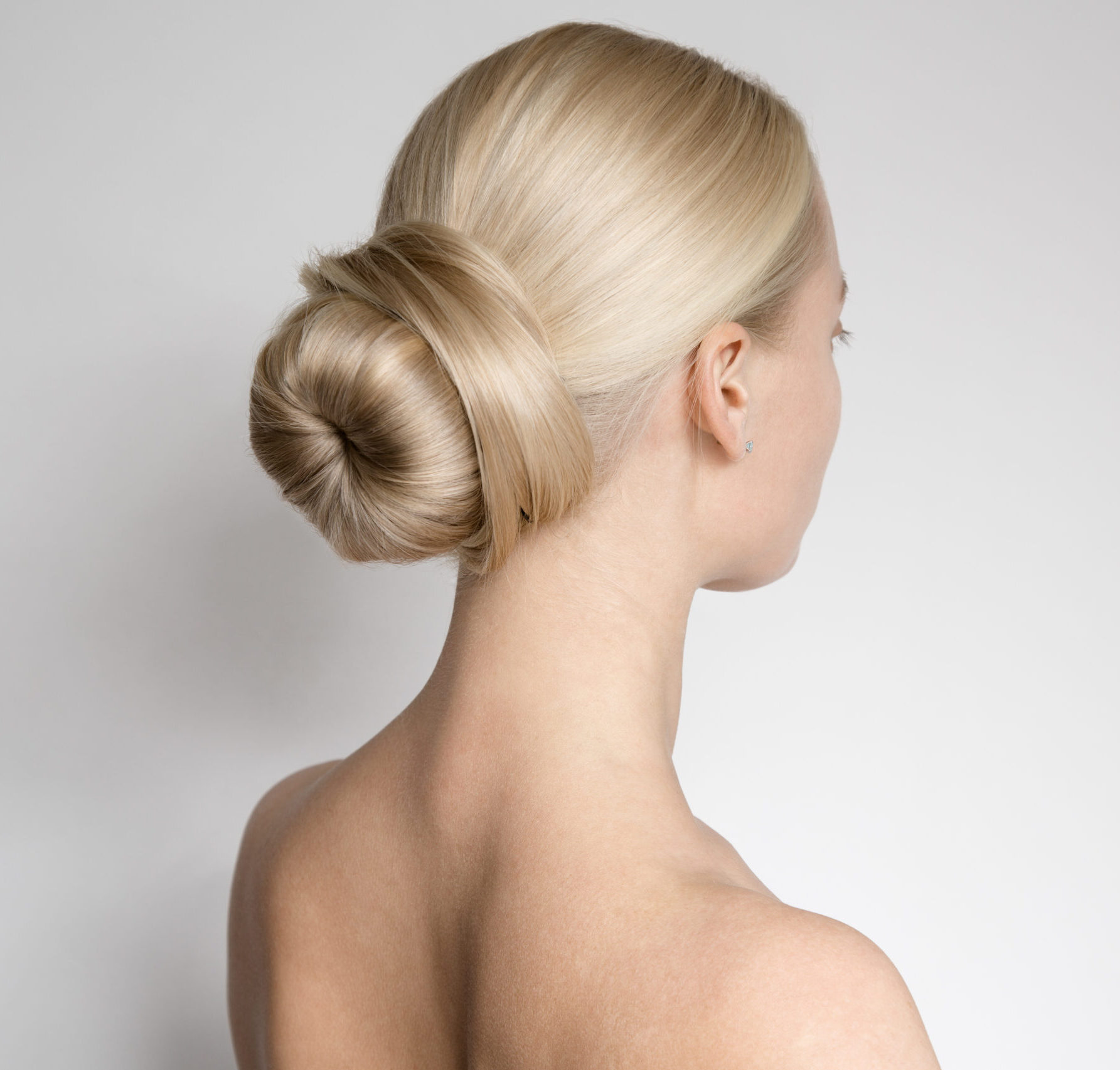 Slicked back low bun wedding hairstyle