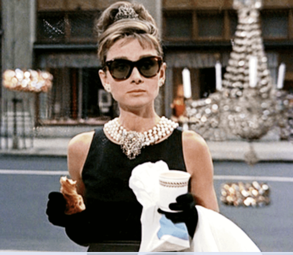 Audrey Hepburn in a black dress and tiara from the movie Breakfast at Tiffany's