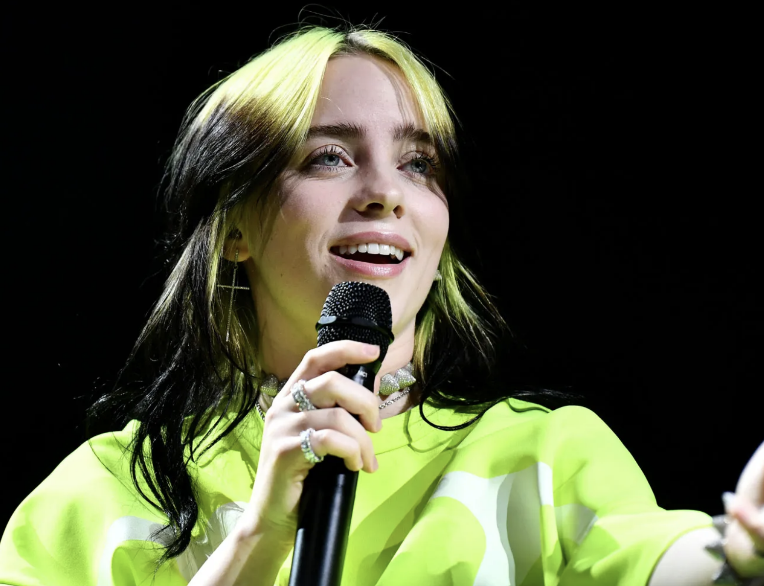 Billie Eilish with bright green and black hair
