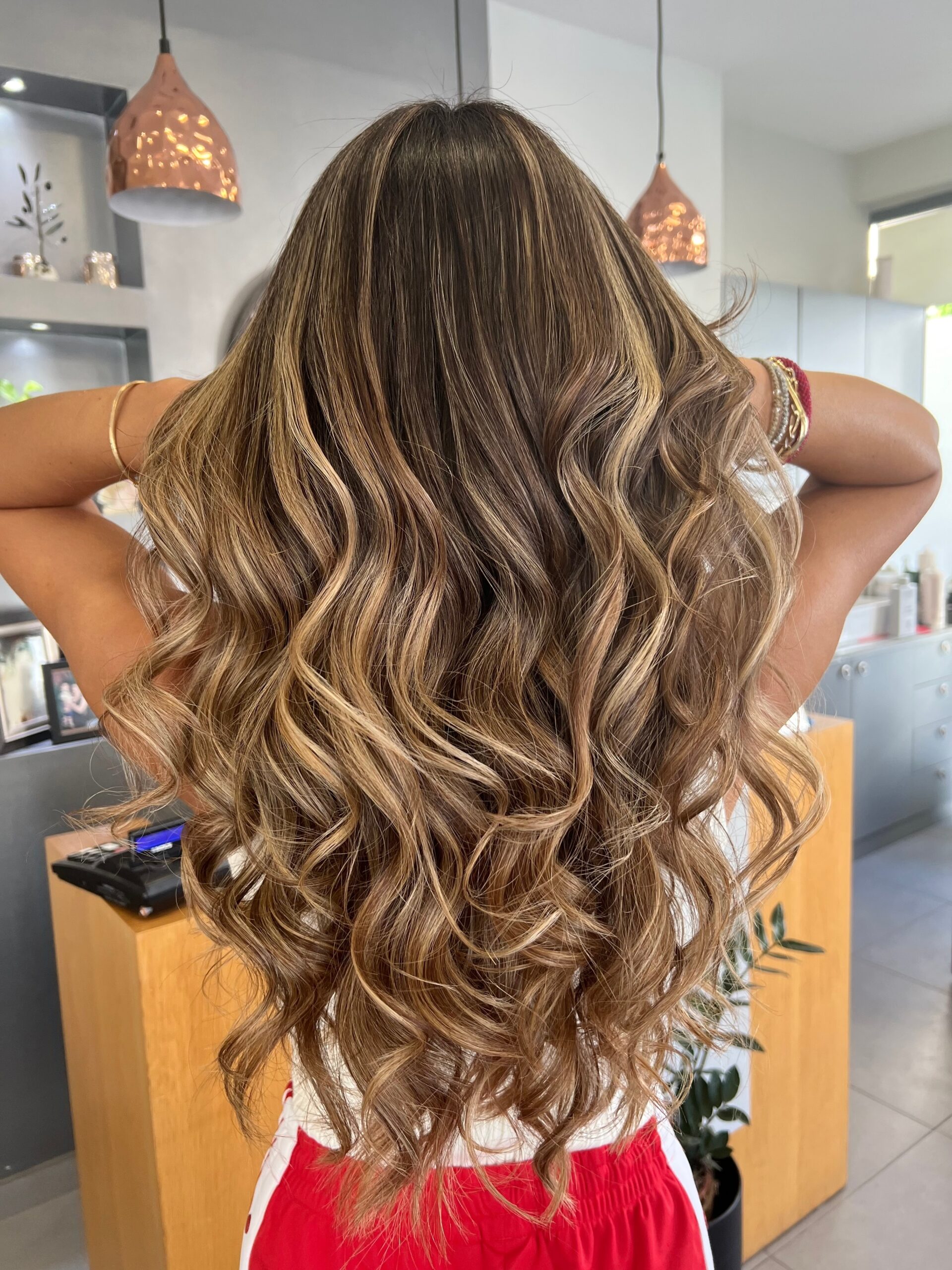 Woman with long flowing balayage hair colour