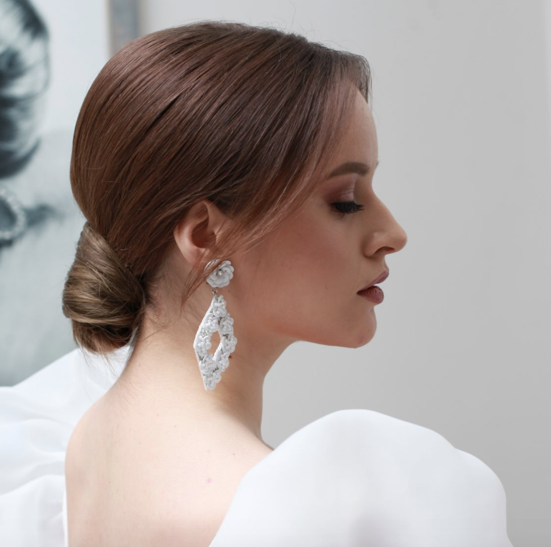 Bride with sleek low bun hairstyle on wedding day