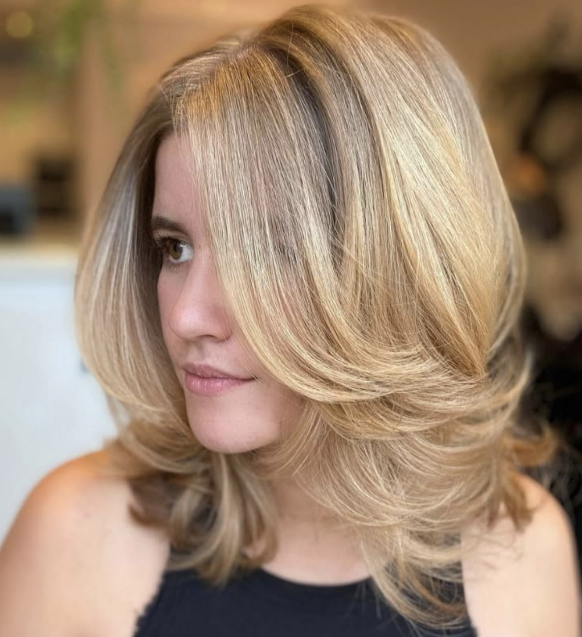 Blonde woman with 90s-inspired layered haircut